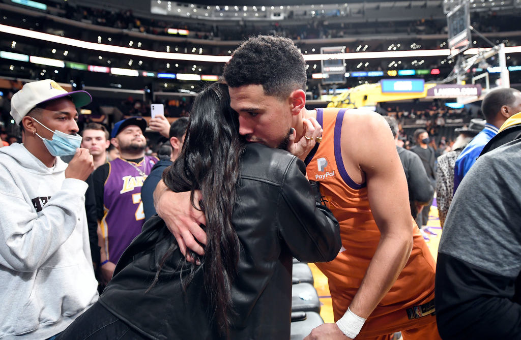 Dustin hugs Kendall from the sidelines of his game