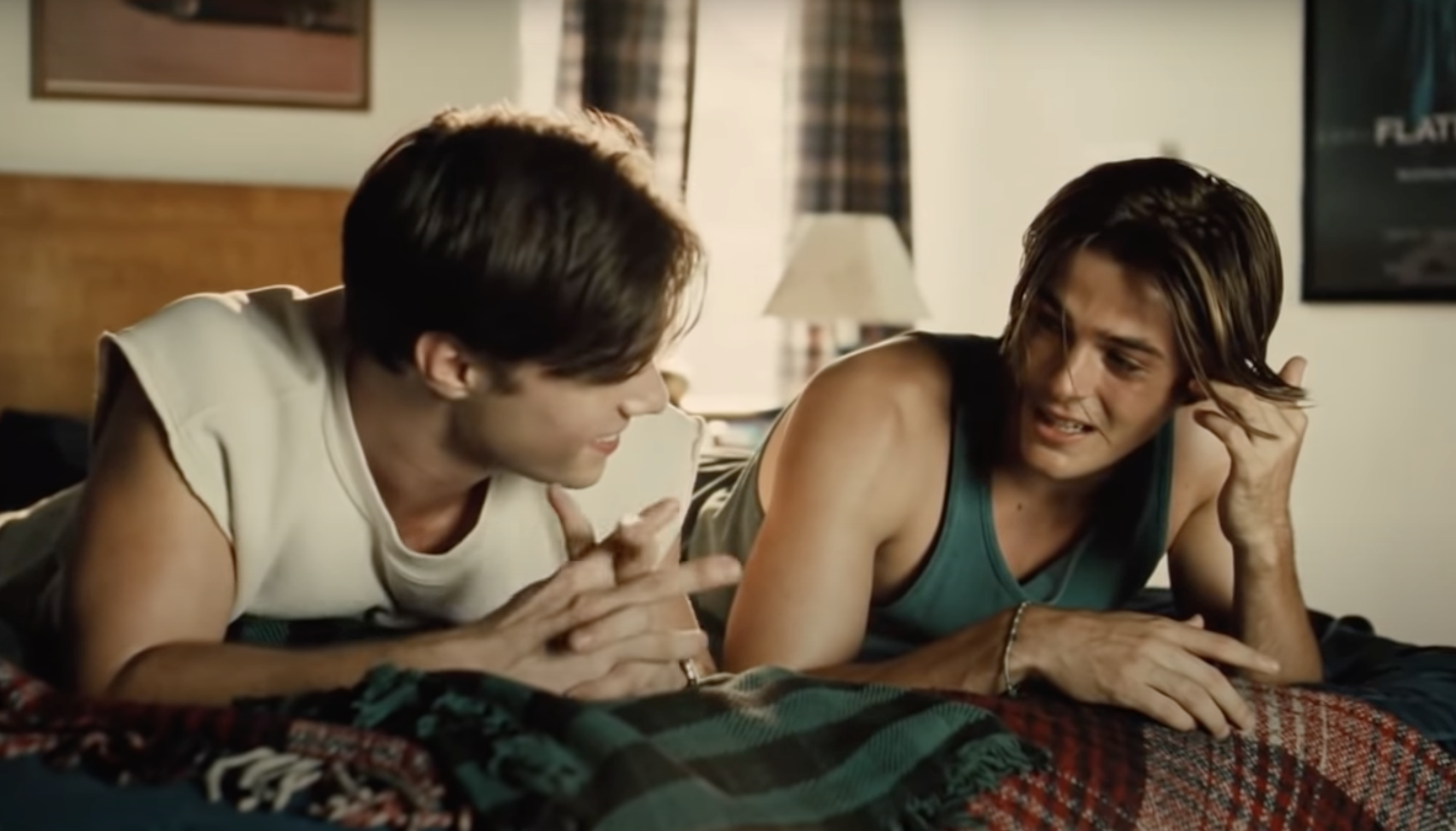 Young Cal and Derek sitting on the bed together