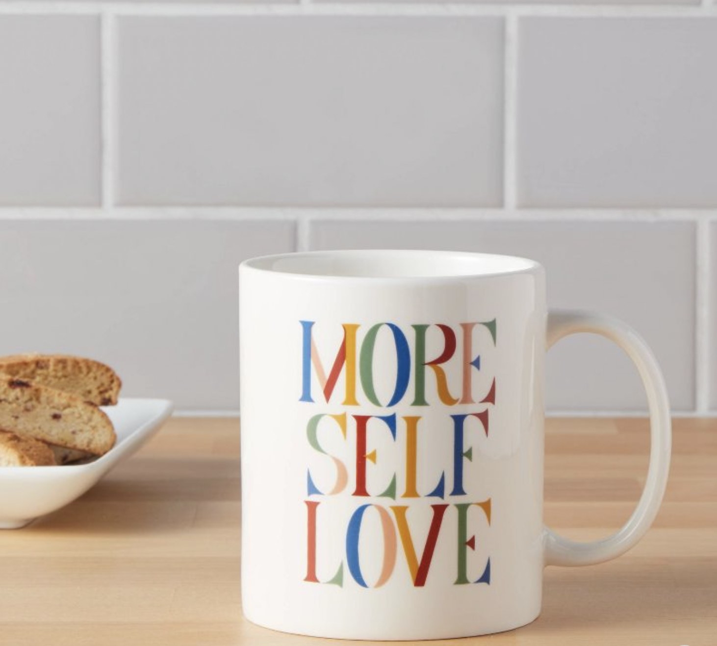The mug with More Self Love in colored letters