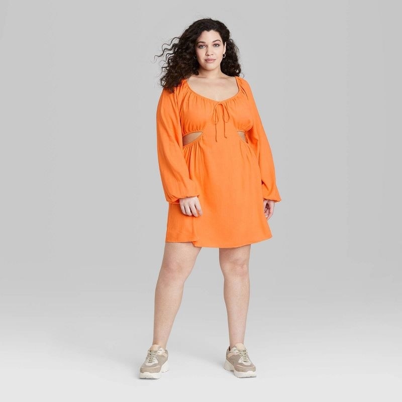model wearing the dress in orange
