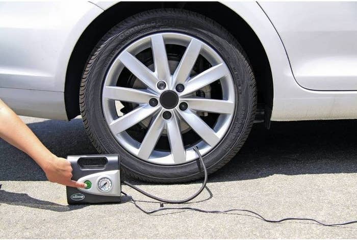 a model using the inflator on a car tire