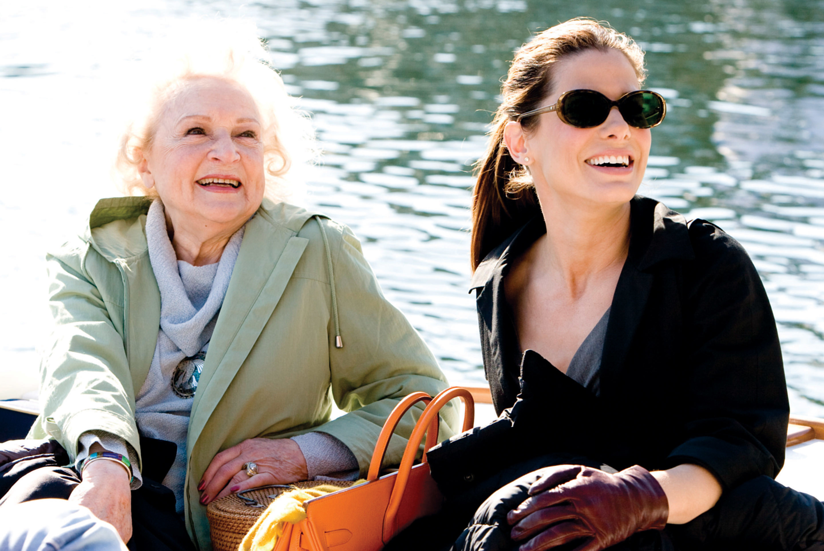 Betty White and Sandra Bullock sit in a boat