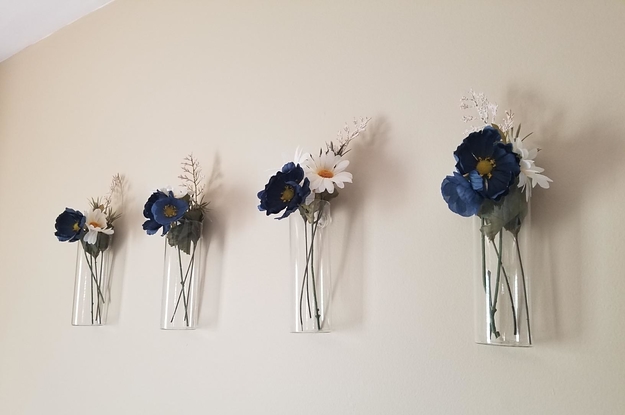 reviewer image of multiple vases with flowers on the wall 