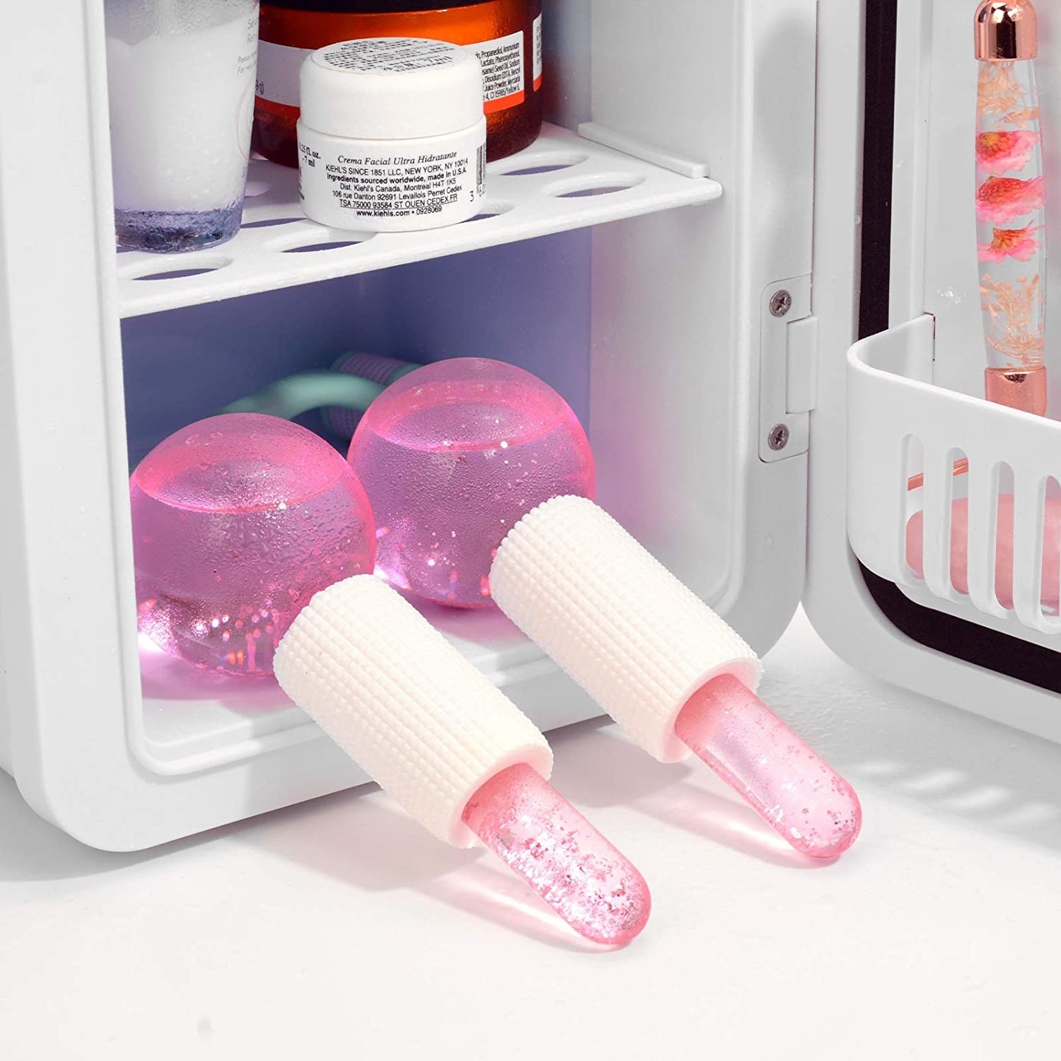 a pair of cold face globes inside a beauty fridge