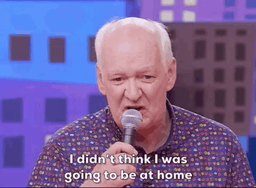 A gif of Colin Mochrie on a microphone and Tom Green cheering him on. The captions read &quot;I didn&#x27;t think I was going to be at home with the freestyle rap&quot;