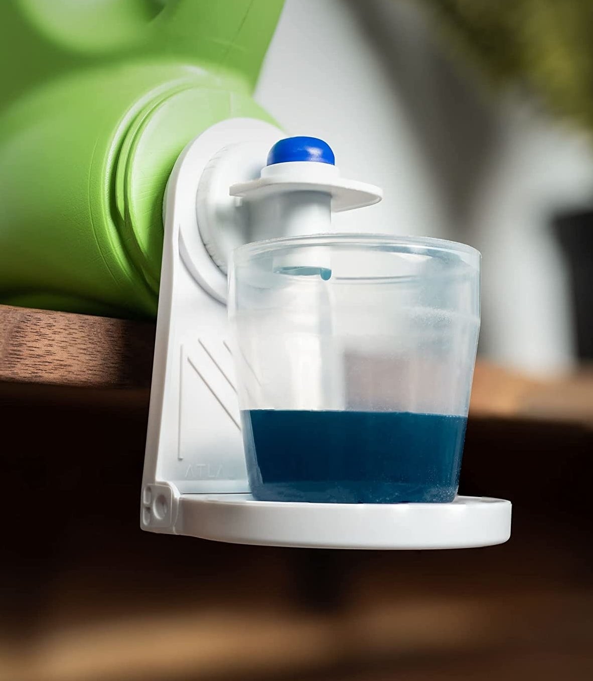 A cup of laundry detergent sitting on the little cup holder