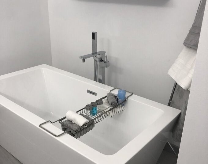 reviewer photo of the caddy over a bath tub