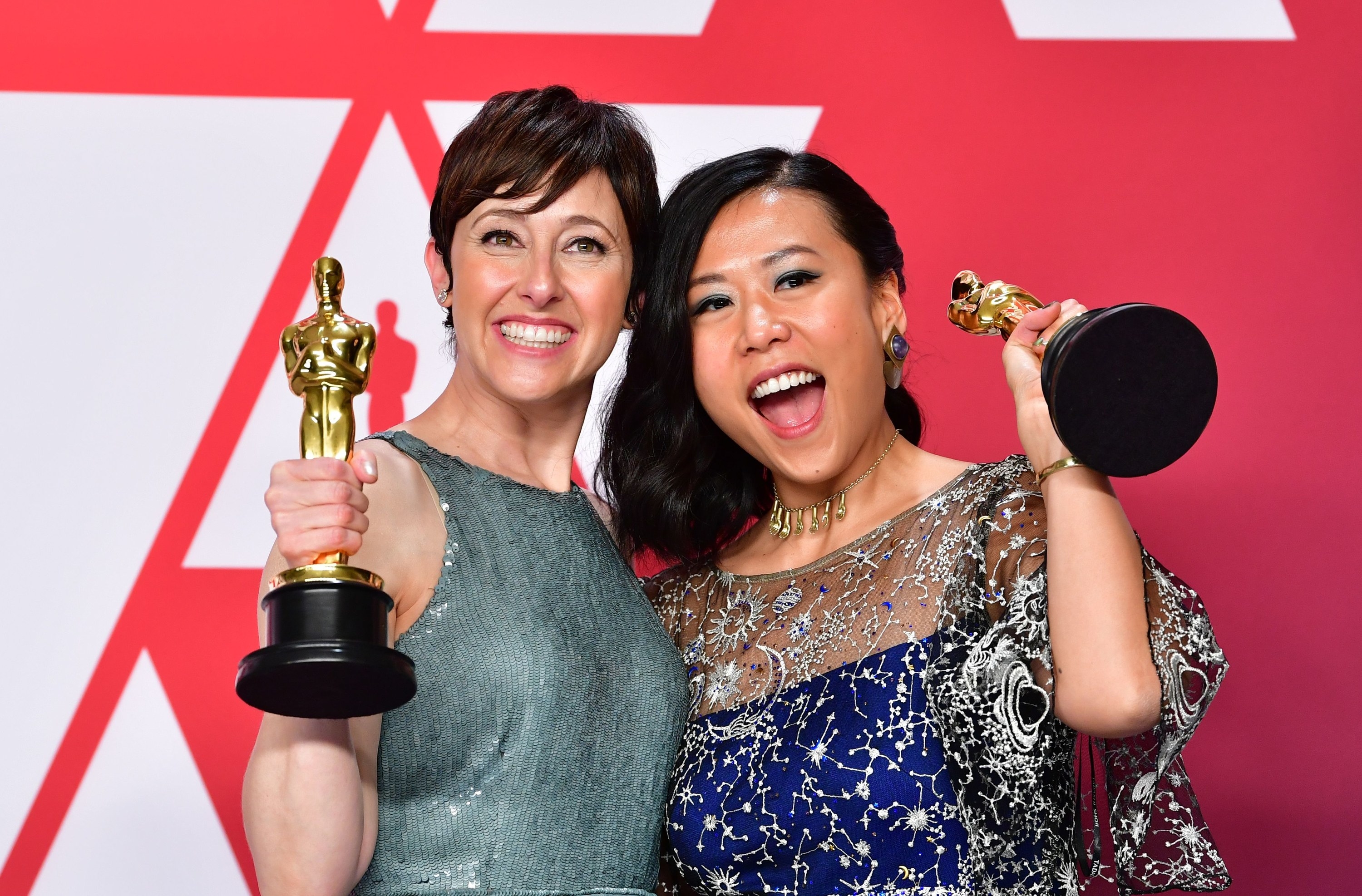 Becky Neiman (left) and Domee Shi pose with their Oscars in 2019