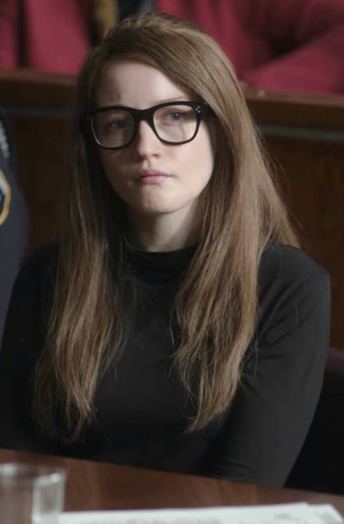 Garner wearing Delvey-like glasses, hairdo, and dress in court