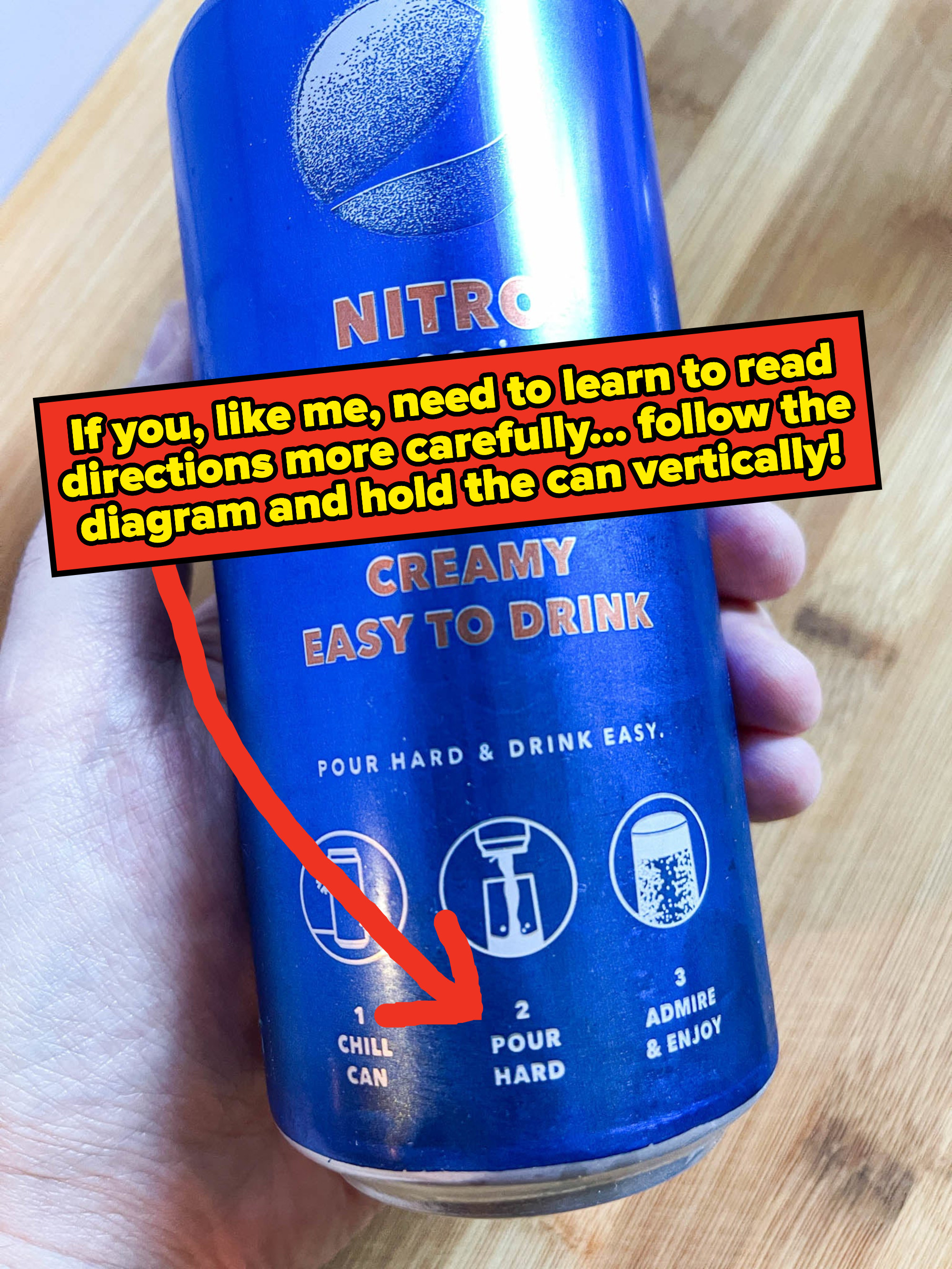 Arrow pointing to a direction on the can instructing people to hold can vertically while pouring hard