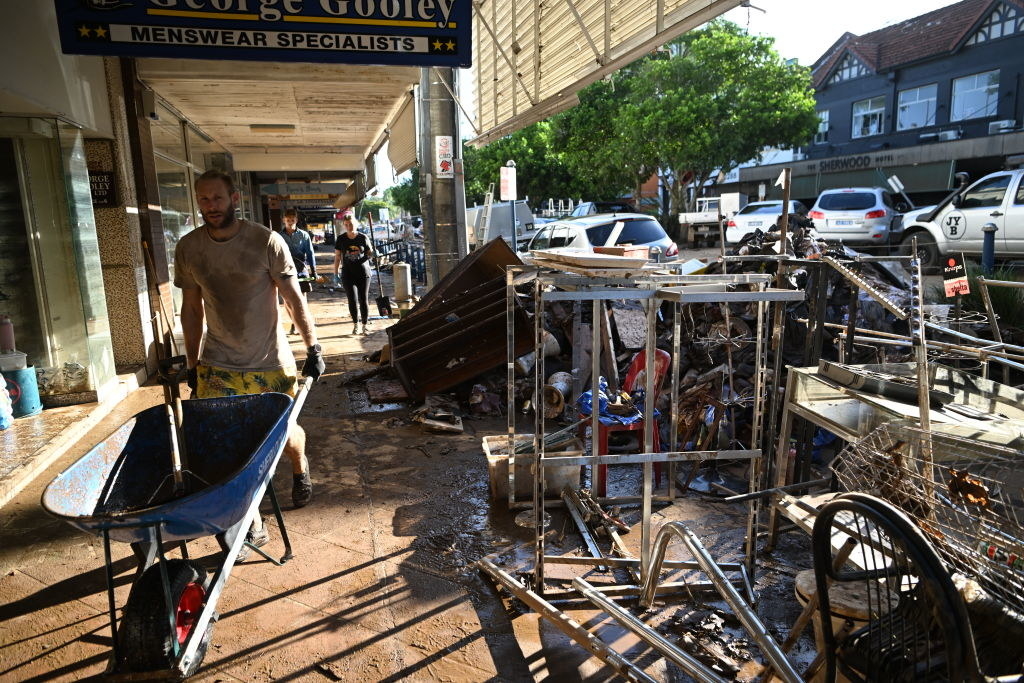 Piles of destroyed goods line the flood affected city centre in Lismore