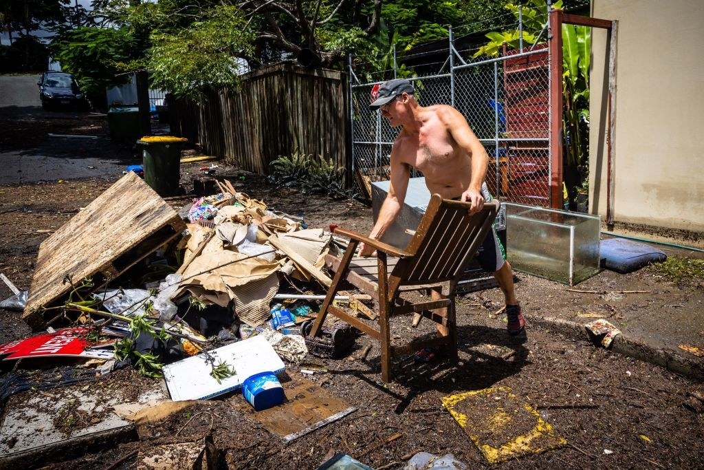 A resident disposes of his flood-damaged belongings