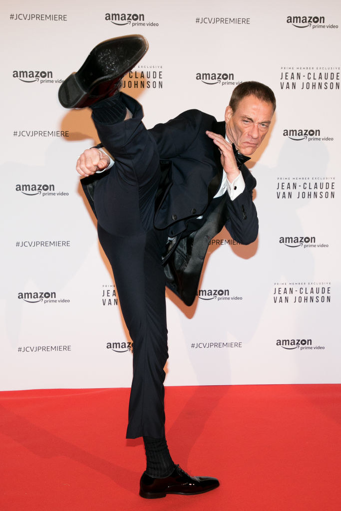 A recent pic of Van Damme doing a high kick in a suit on the red carpet