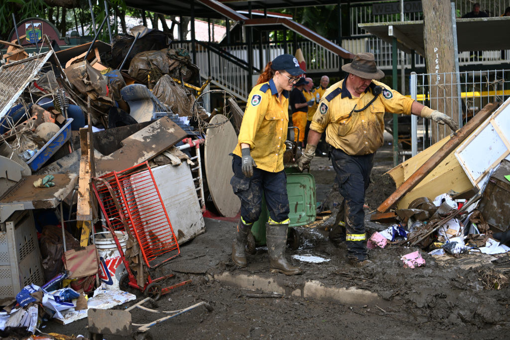Volunteers from the local Rural Fire Brigade help to clean up a flood-affected primary school