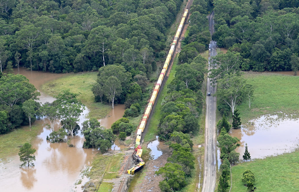 In an aerial view, a train is derailed in an accident caused by flooding in the town of Gympie