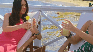 two people cheersing with a drink while on a porch in fox&#x27;s &quot;coupled&quot;