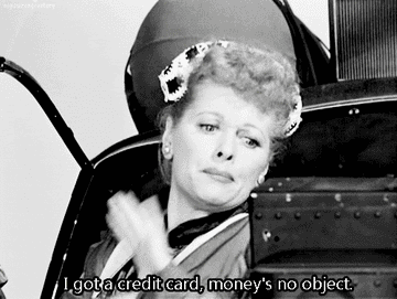 a gif of lucille ball shouting, &quot;I got a credit card, money&#x27;s no object!&quot; from the back of a car