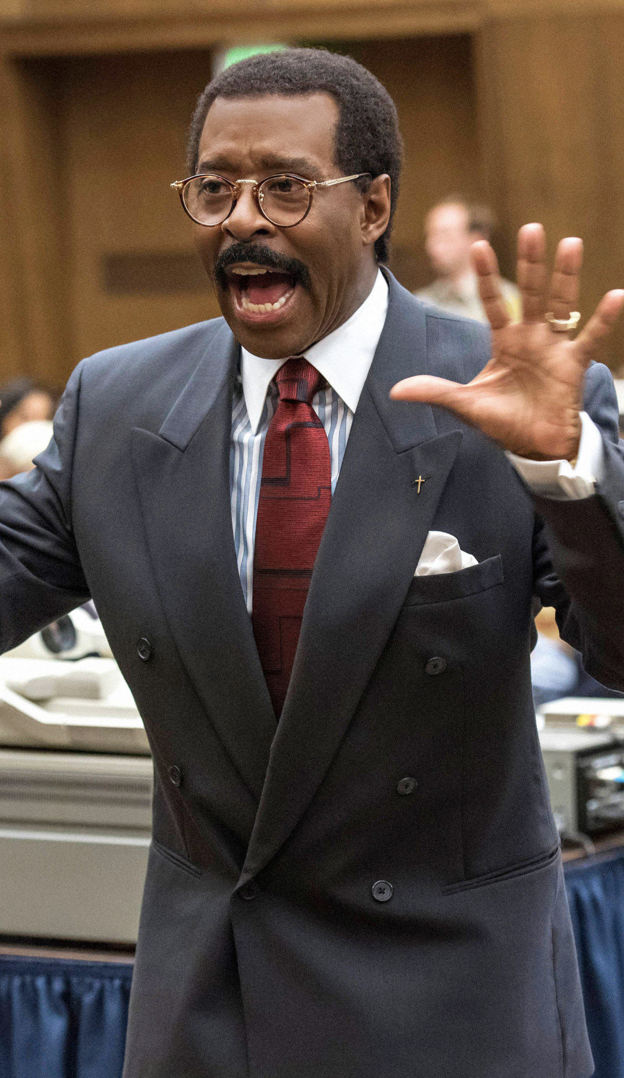 Vance wearing Cochran&#x27;s infamous glasses and suit; Putting his hands up in court