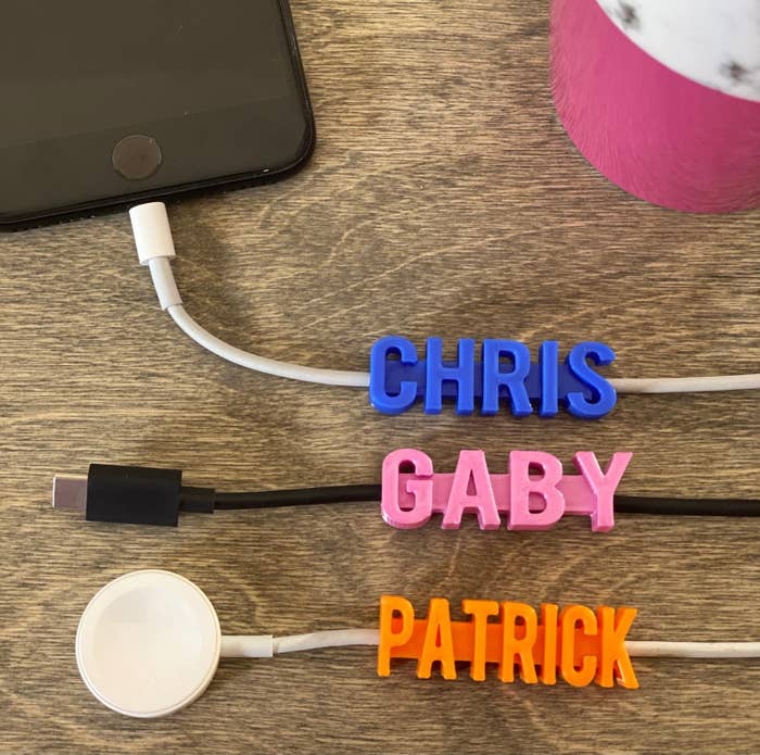 A variety of charges all with a personalized charger cable name tag labeling who they belong to