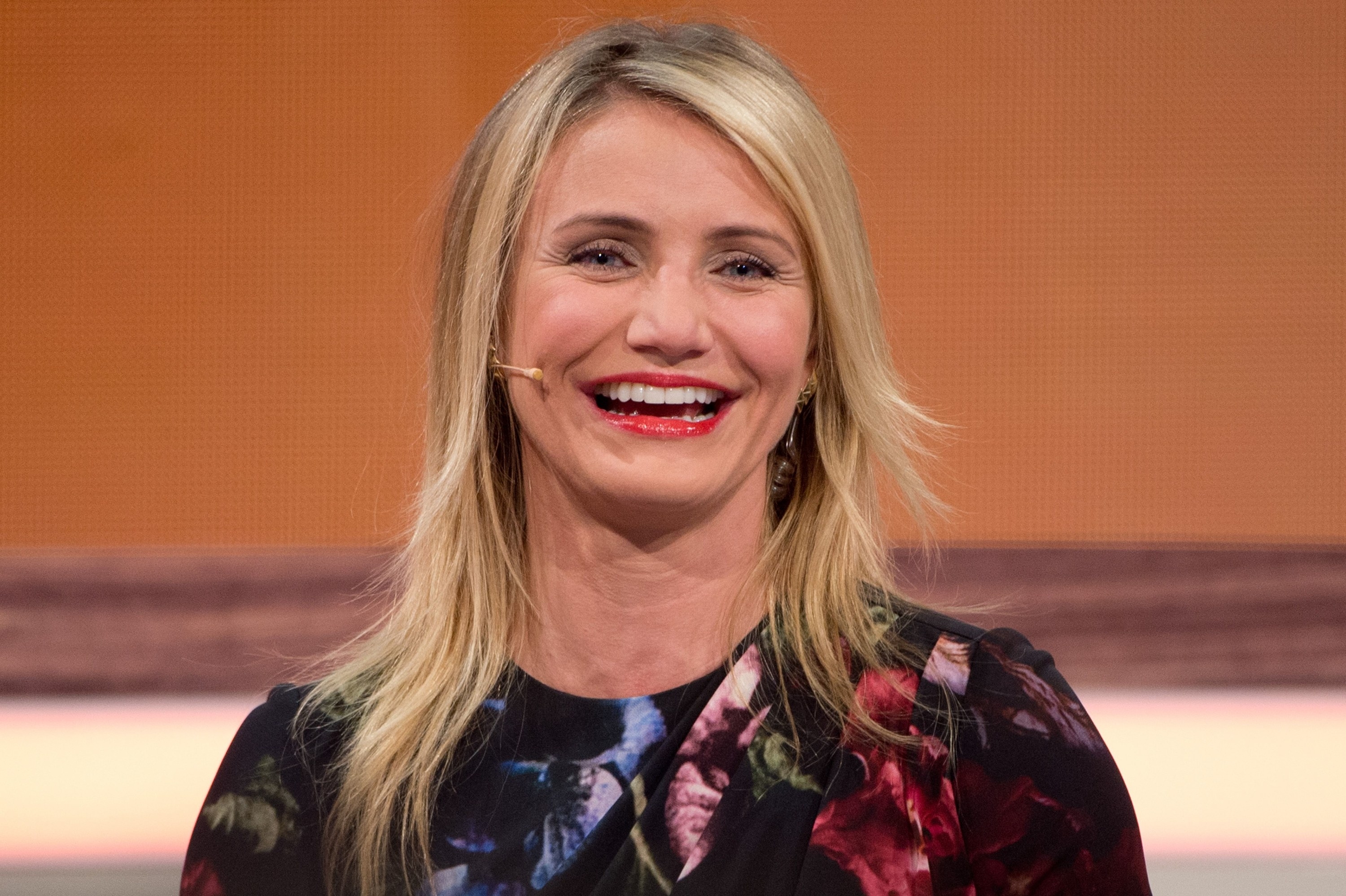Cameron Diaz laughing with a head mic attached to her