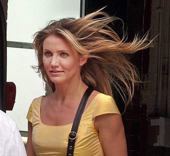 Cameron Diaz walking down the street with her hair blowing in the wind