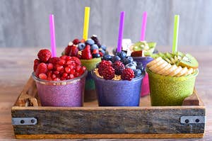 a tray of colorful smoothies