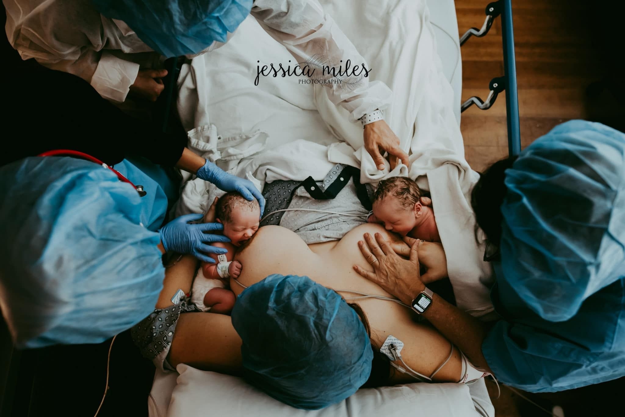 A woman tries breastfeeding twins, one on each breast, immediately after delivery