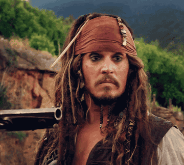 Jack Sparrow looking repulsed at someone holding a gun