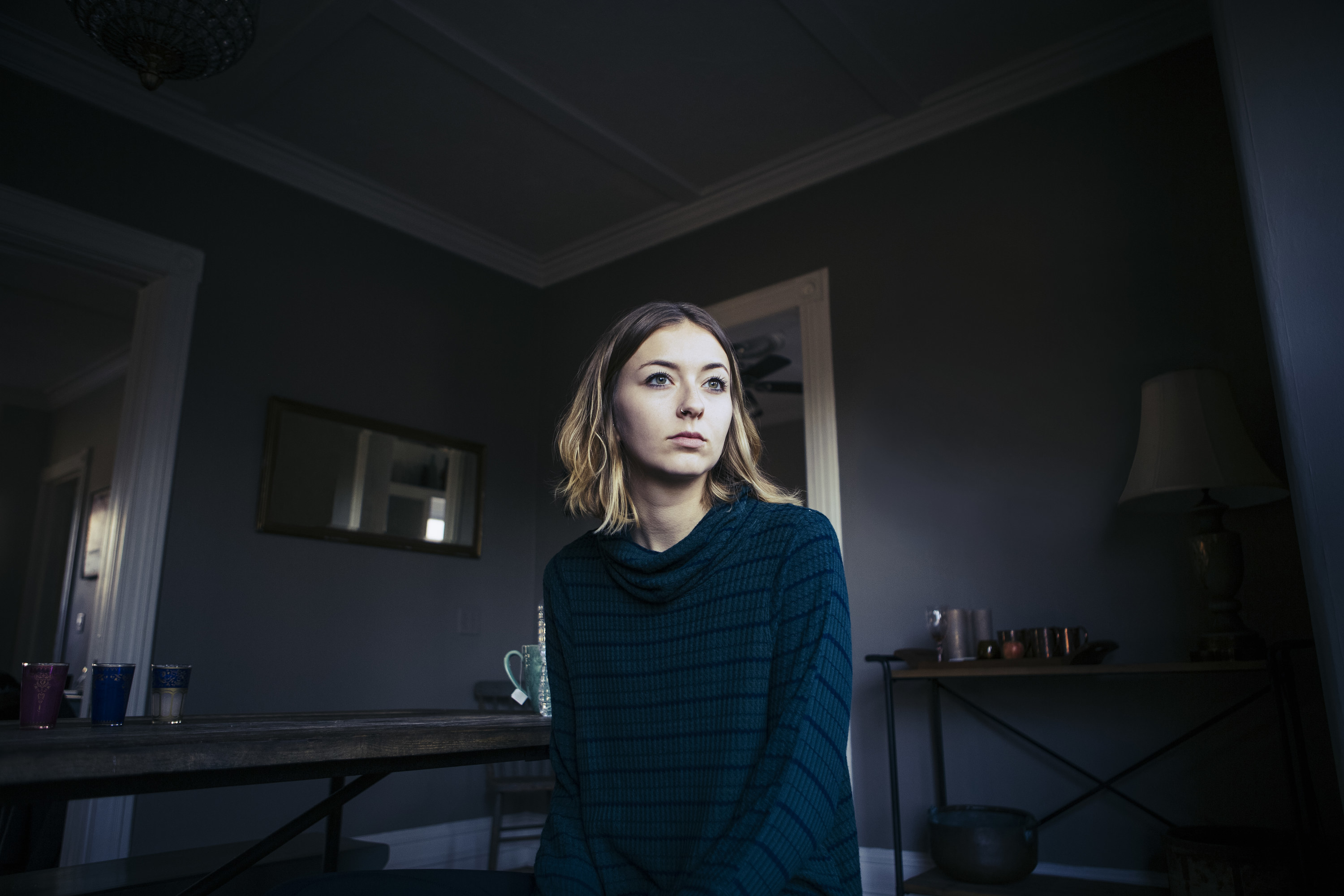 A woman alone in her house with the lights off