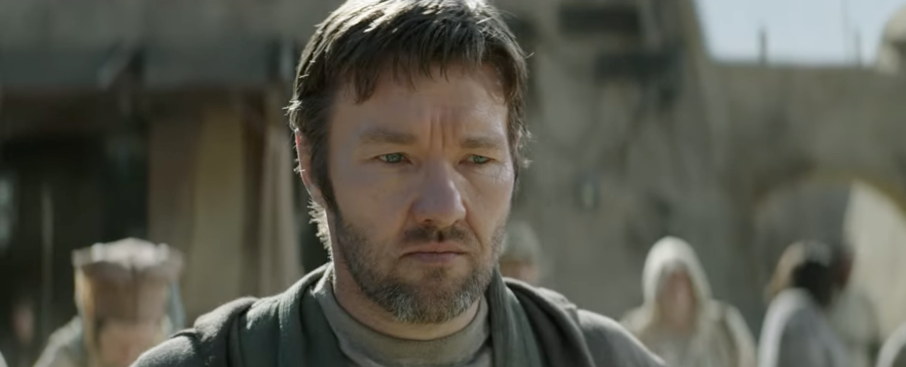 A closeup of Joel looking down in a scene from the series