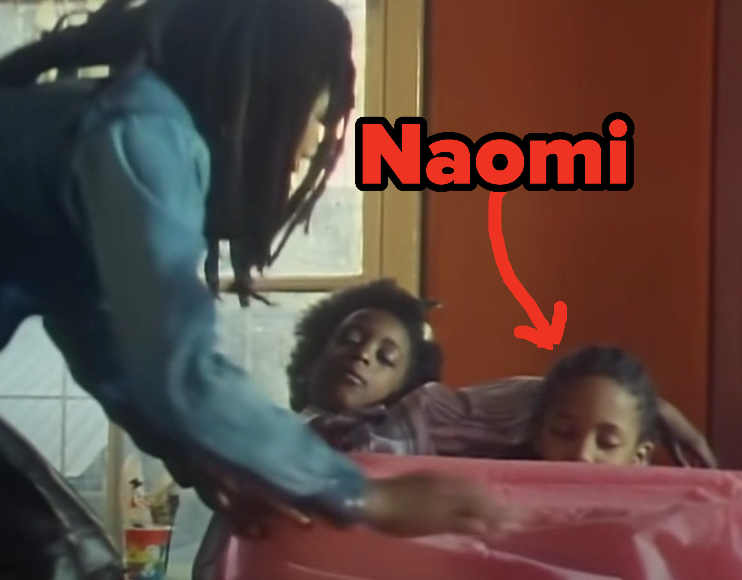 Naomi Campbell is tucked in by Bob Marley along with another child in his music video for &quot;Is This Love&quot;