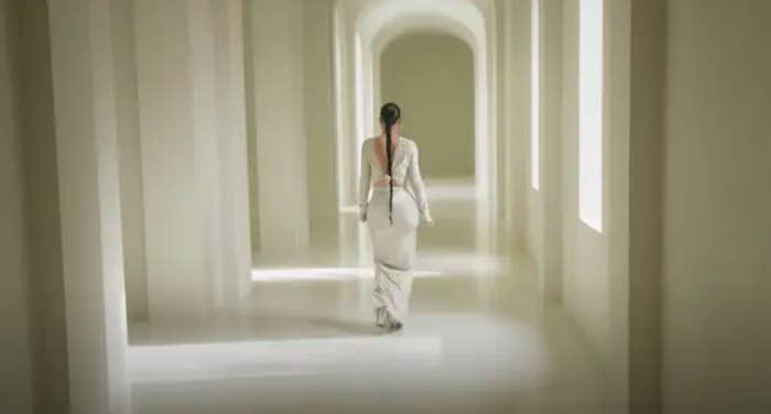 Kim walking down one of her museum-like sterile empty hallways