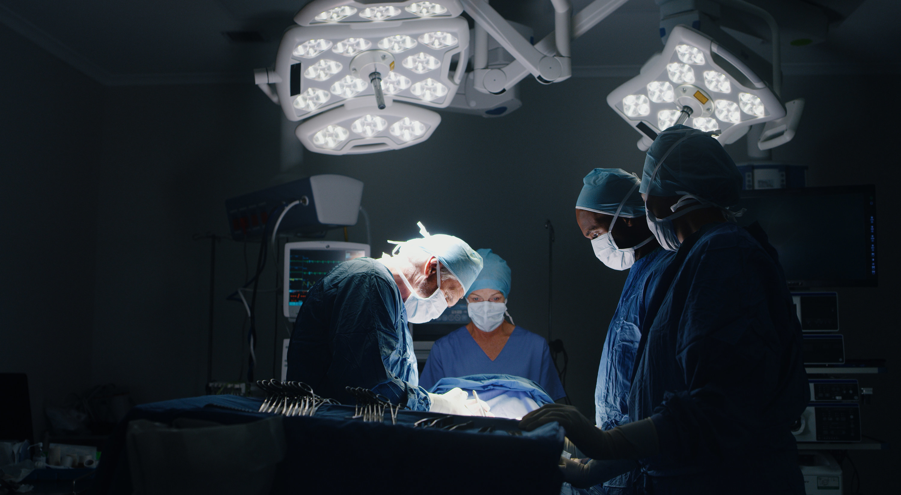 Surgeons standing around in an operating room