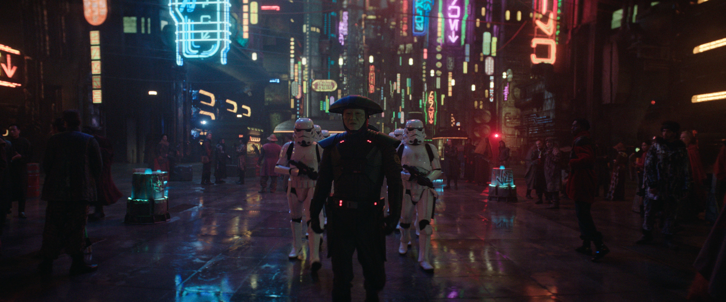 Sung Kang with storm troopers behind him in a city