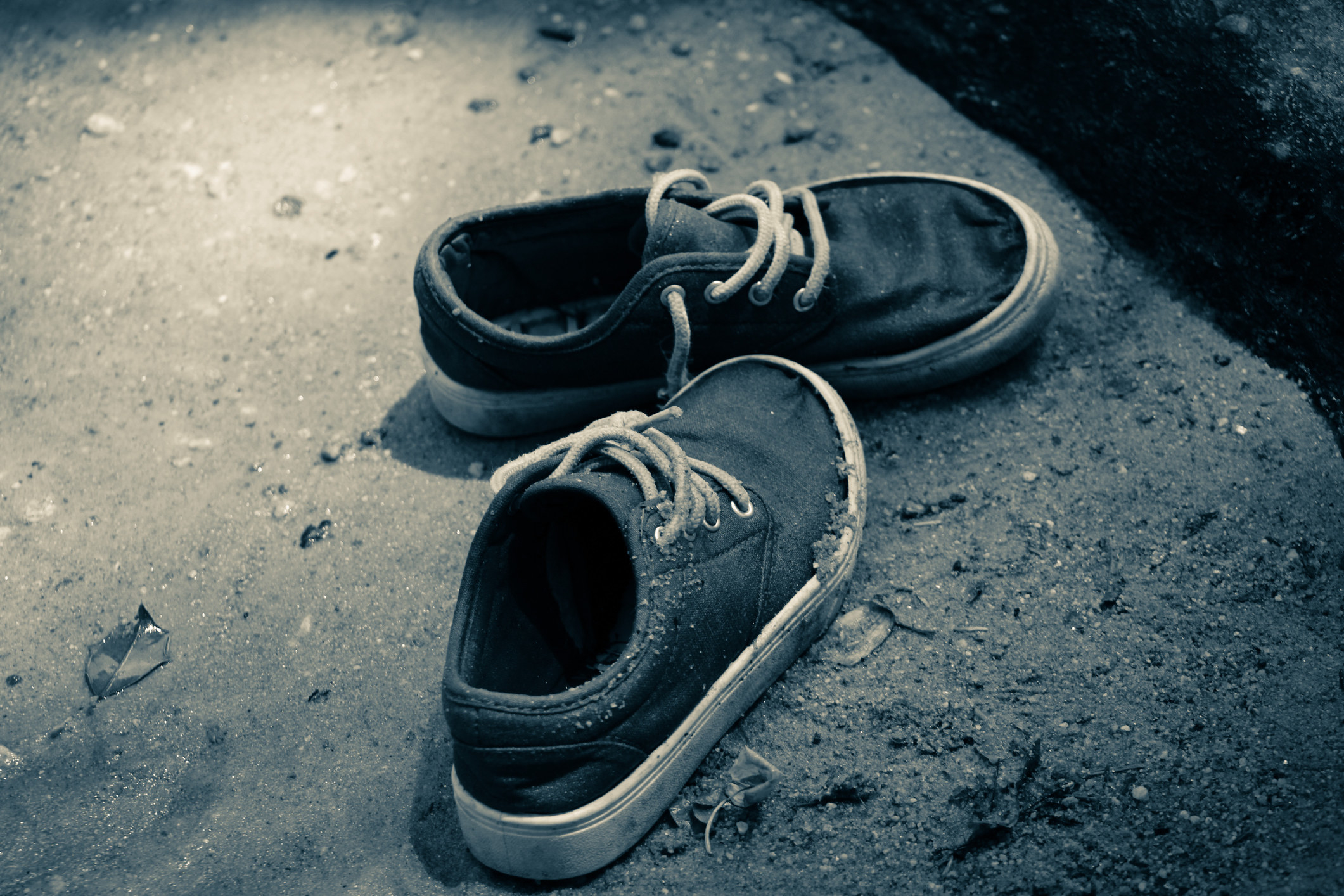 a pair of worn shoes on the street