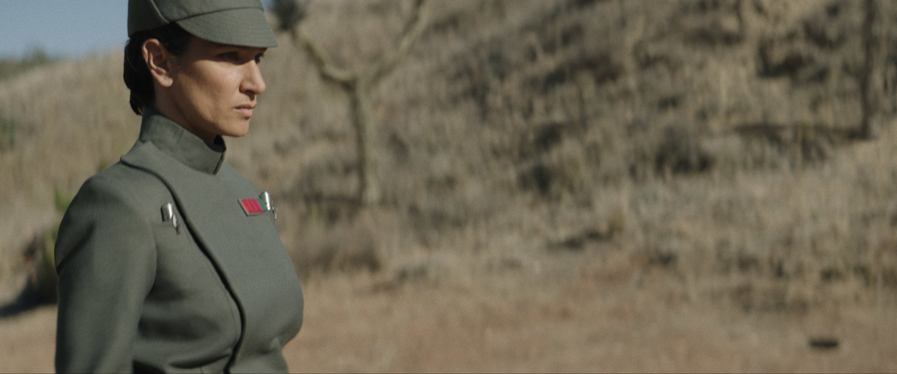 Indira Varma in an Imperial officer uniform and keeping watch