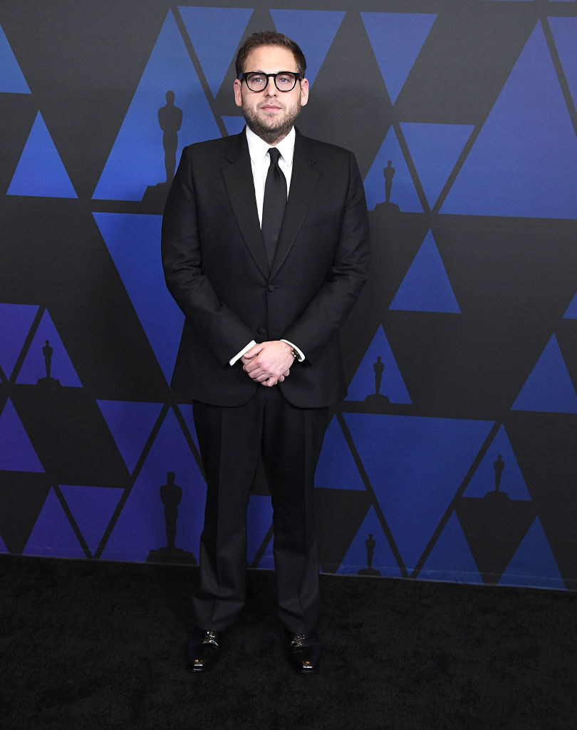 on the red carpet, Jonah wears a classic tux and glasses