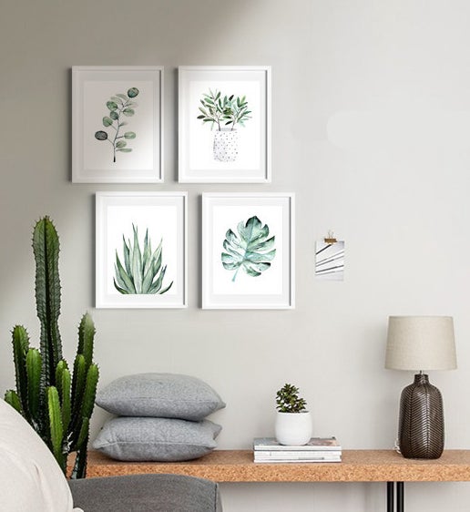the set of prints in frames hanging on a wall together in a living room
