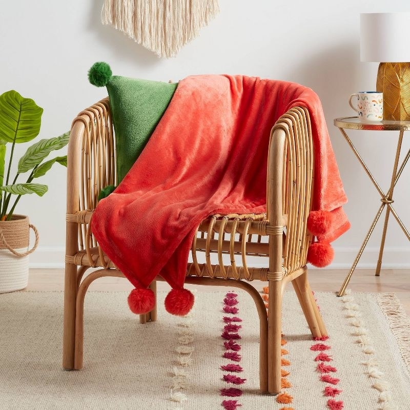 the red blanket on a brown chair