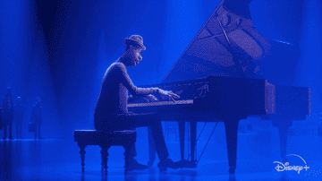 Joe playing the piano while lights swirl around him