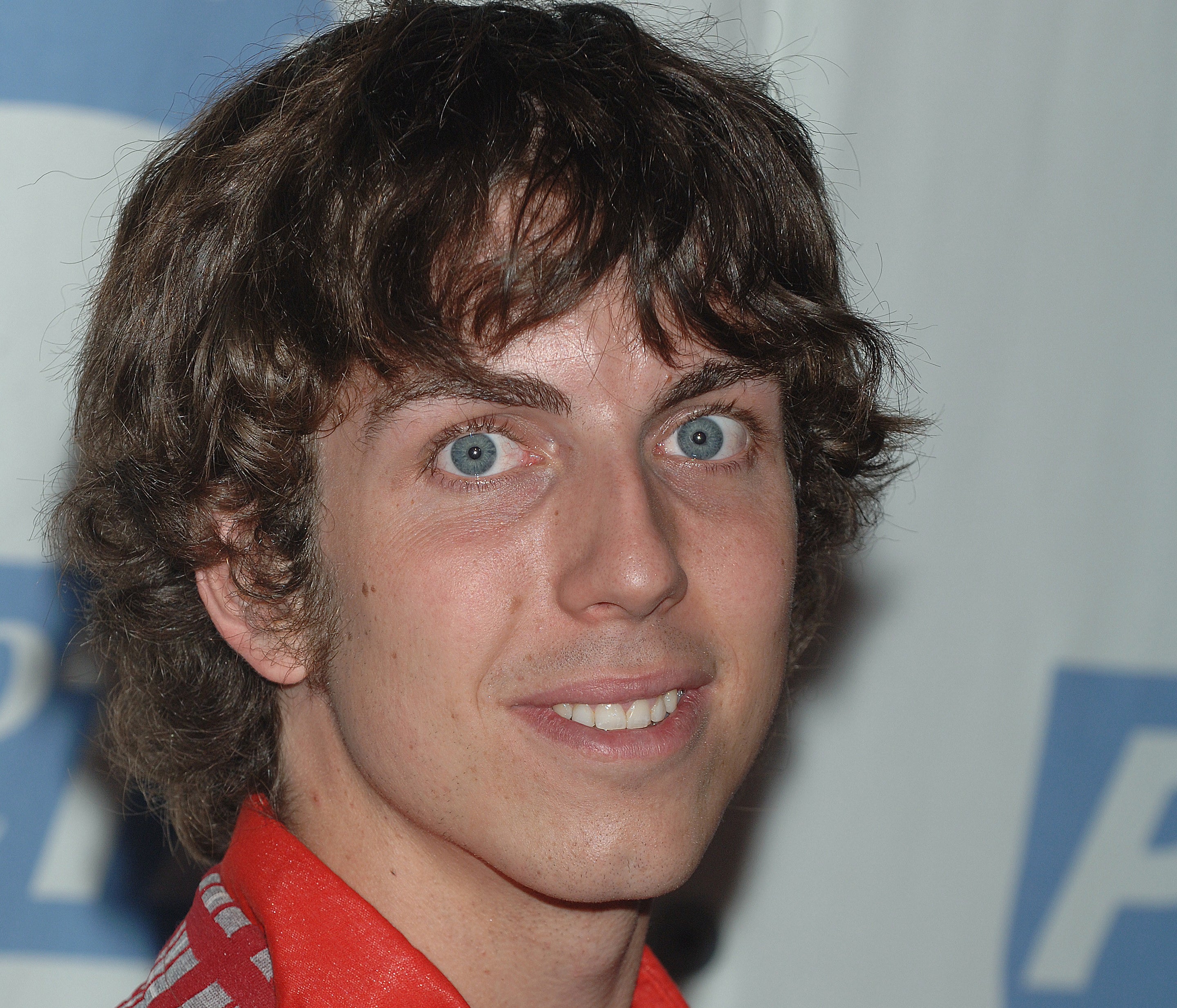 Taran Noah Smith at a press event smiling at the camera