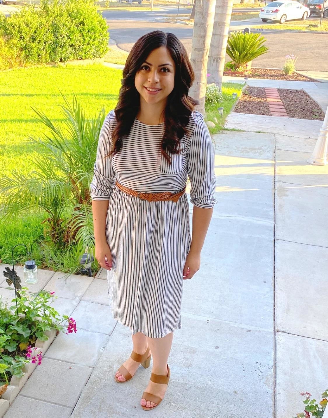reviewer wearing the dress in gray stripes