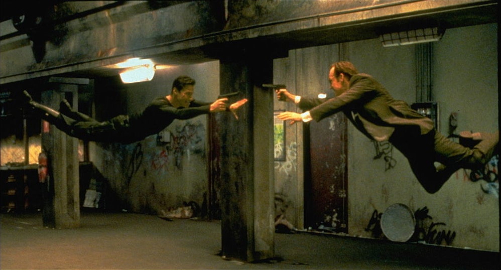 Keanu Reeves and Hugo Weaving face each other in a scene from the Wachowski&#x27;s 1999 movie The Matrix