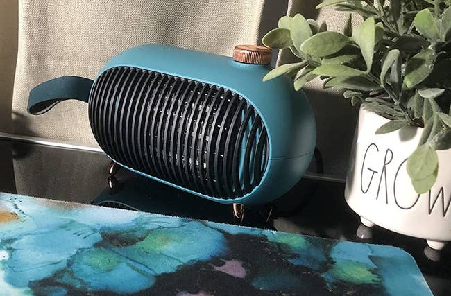 A reviewer image of the turquoise green heater with gold top knob