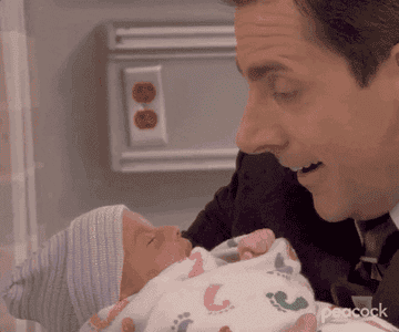Michael Scott holding a newborn on &quot;The Office&quot;