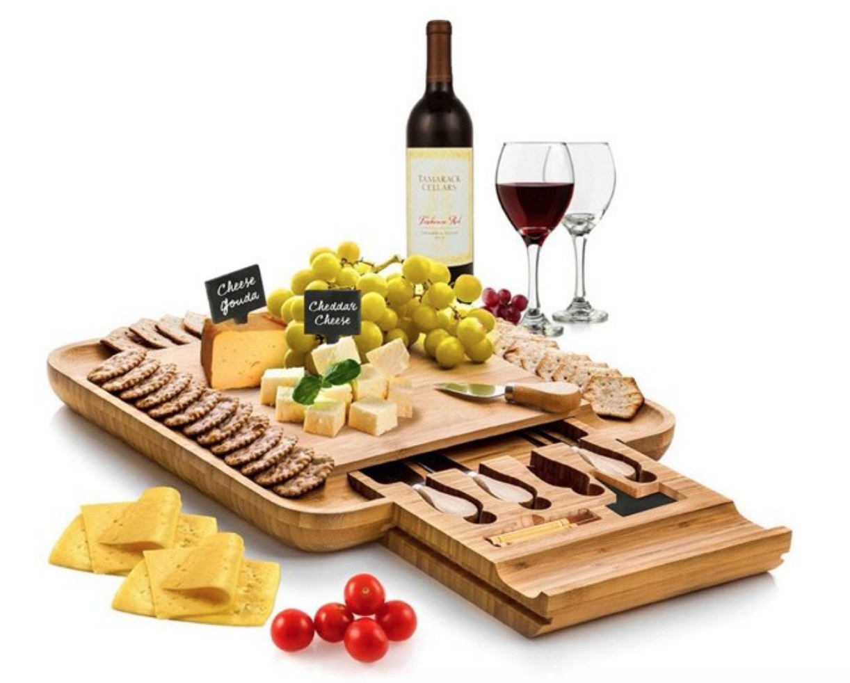 A bamboo cheese board with utensils