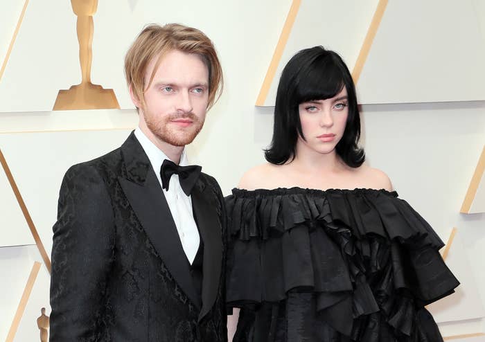 the siblings stand together on the red carpet