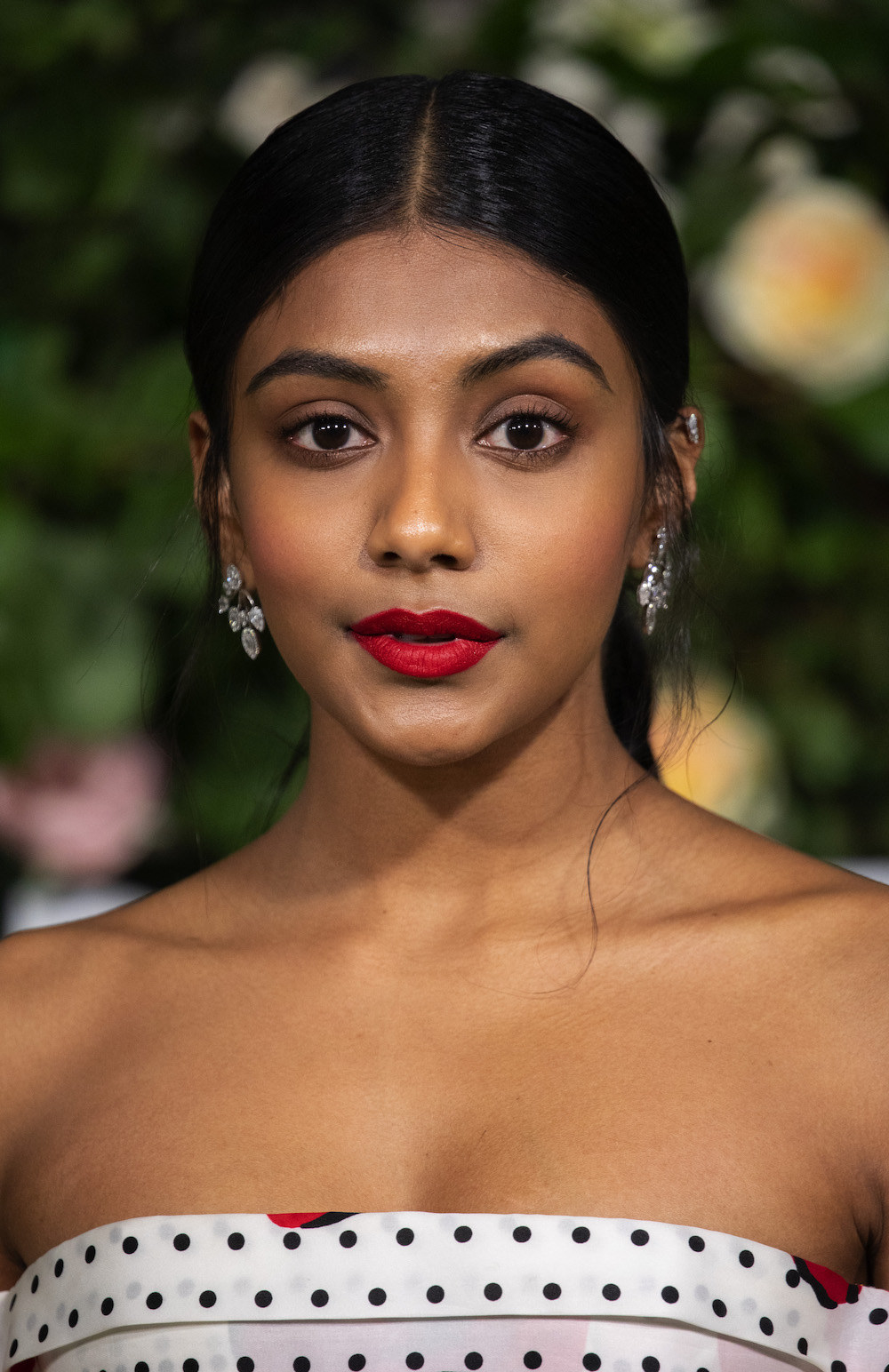 A closeup of Charithra at a red carpet event