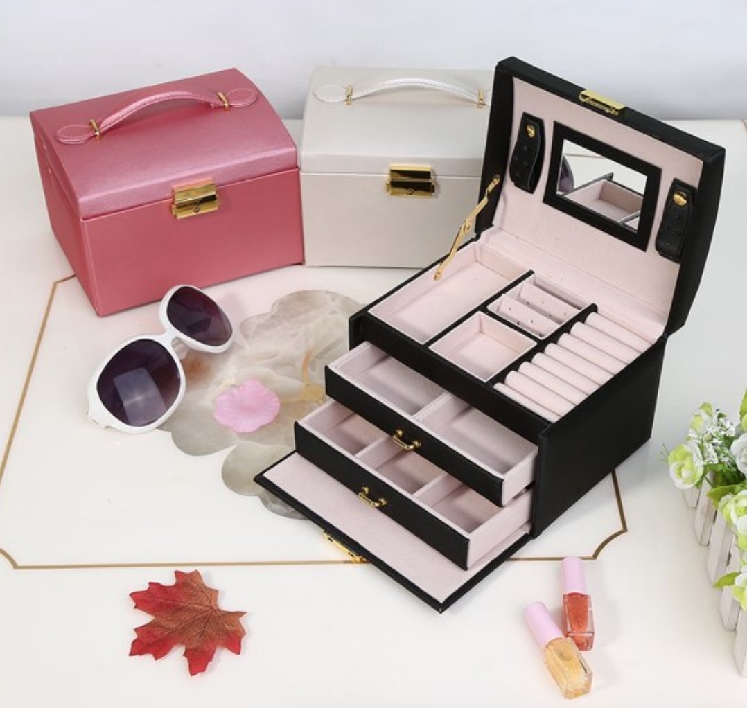 A black, pink, and white jewelry box