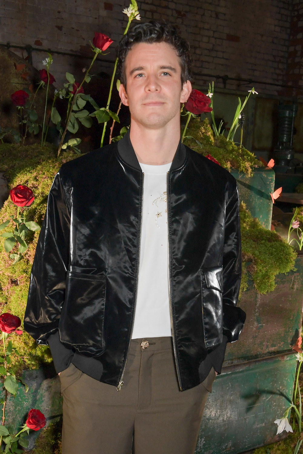 Luke posing in a casual jacket at an event